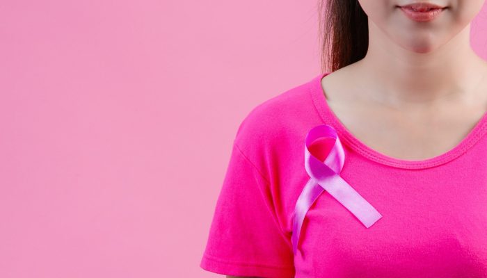 breast-cancer-awareness-woman-pink-t-shirt-with-satin-pink-ribbon-her-chest-supporting-symbolbreast-cancer-awareness (1)